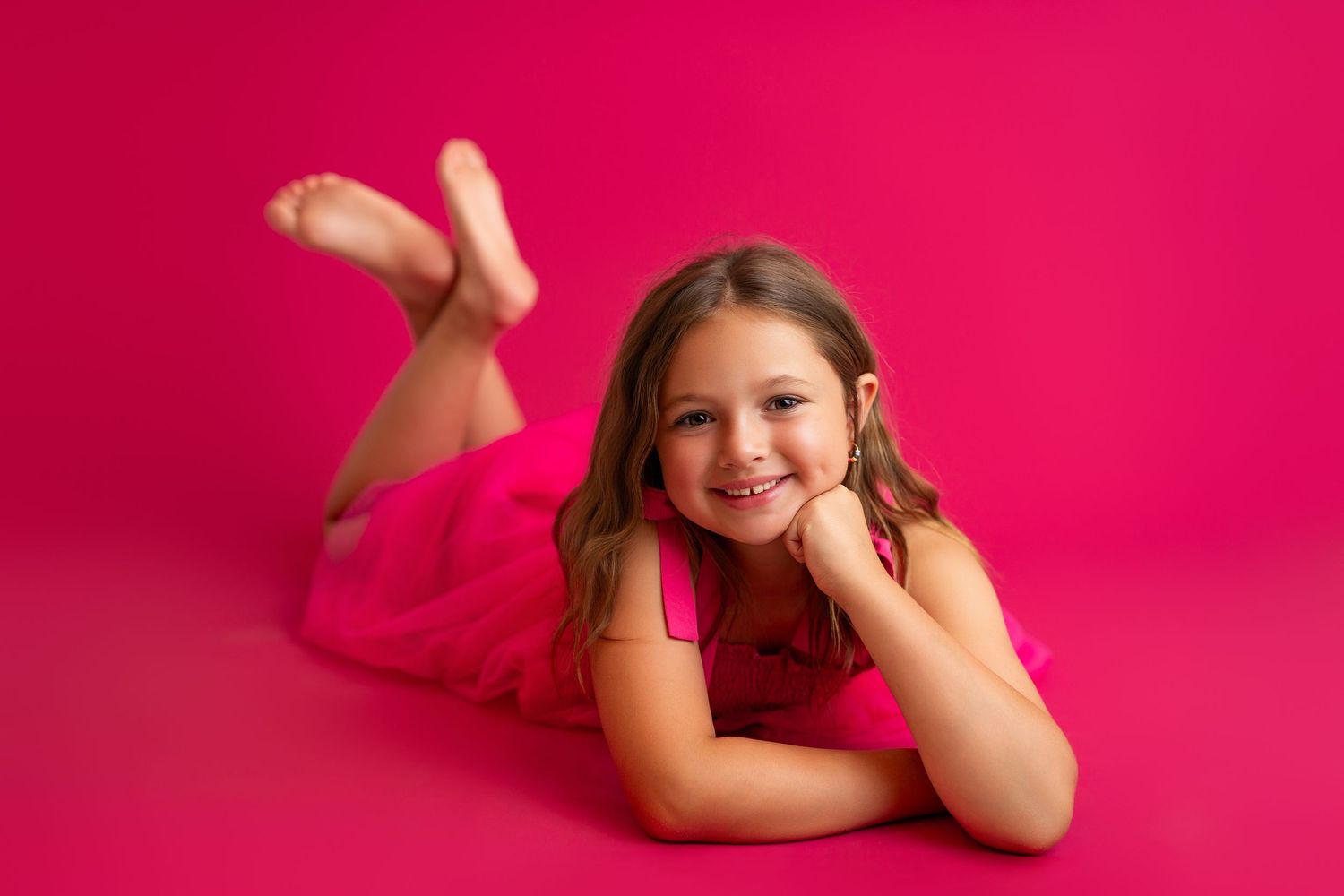 Vibrant pink background setup for professional photography session.