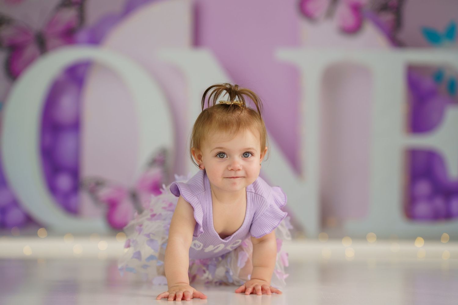 Dreamy purple room setup with butterfly wall decor and soft lighting.