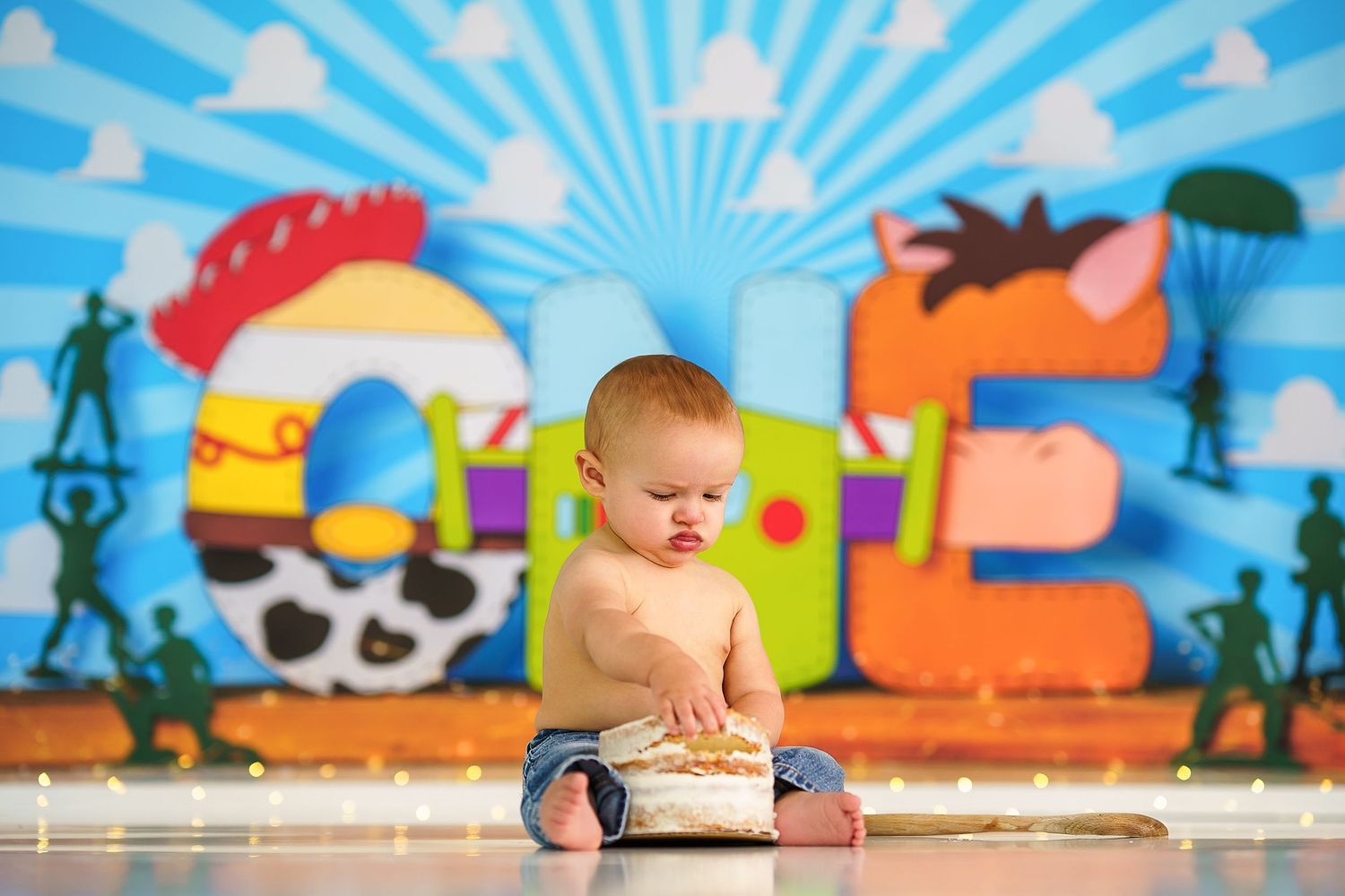 Colorful cartoon backdrop featuring blue sky and playful outdoor elements.