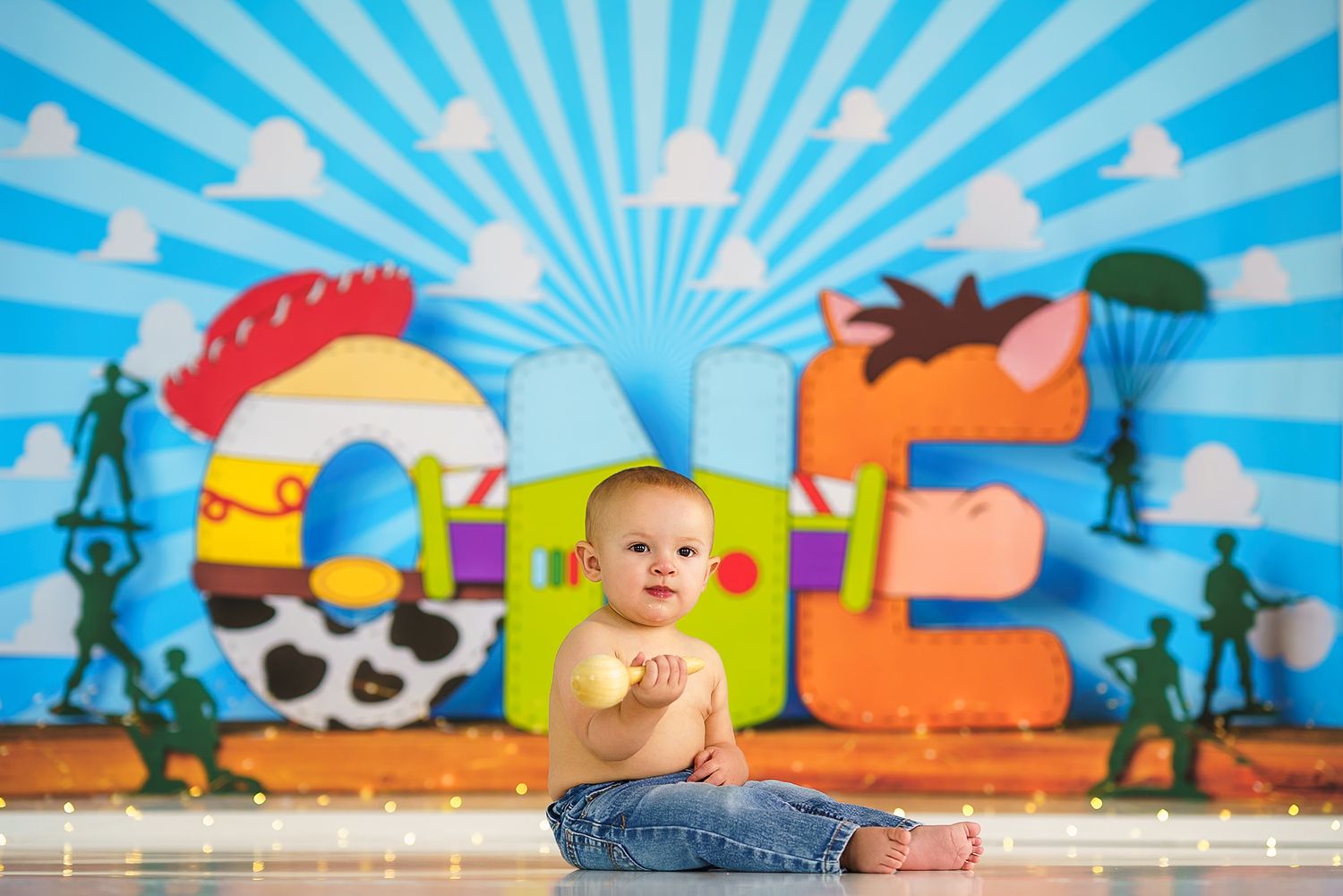 Bright blue sunburst background with colorful cartoon characters for baby photos.