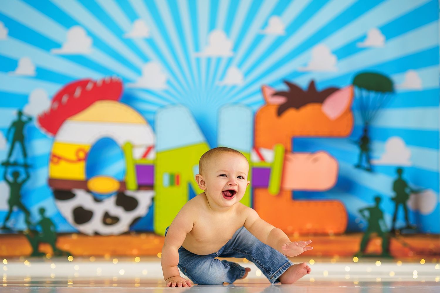 Colorful cartoon backdrop with sunburst pattern for baby photo session.