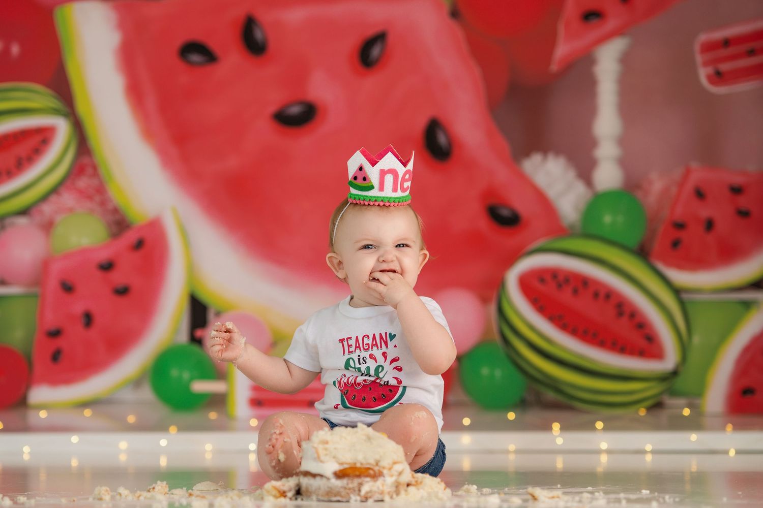 Colorful watermelon-themed party setup with decorative lighting and festive elements.