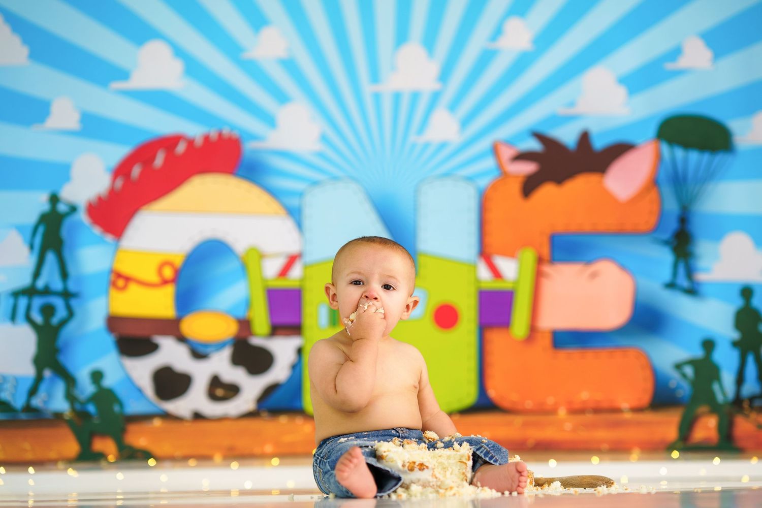A creative cake smash photo setup with bright blue sunburst background.