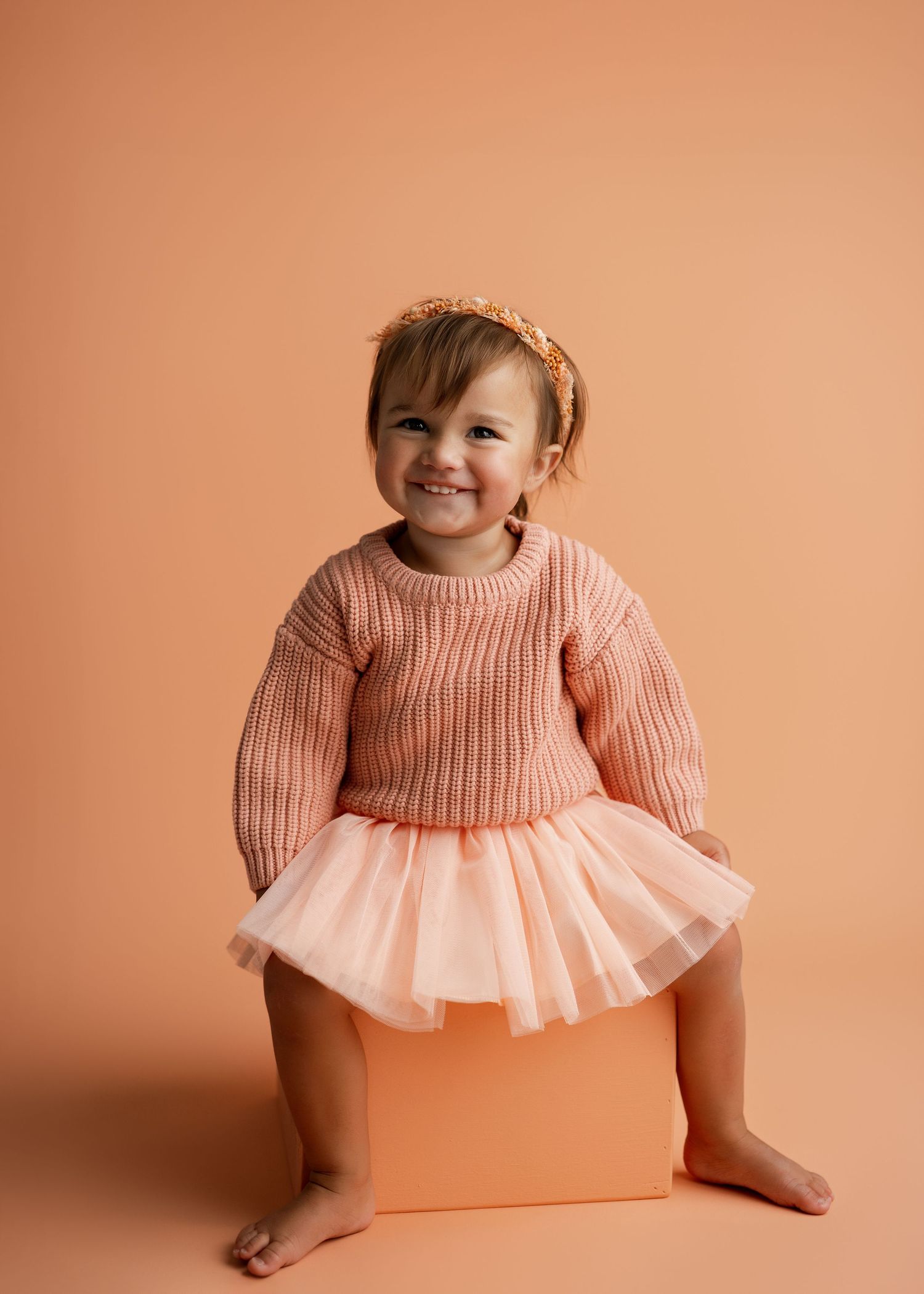 Fashion photography series featuring peach sweater and tulle dress combinations.
