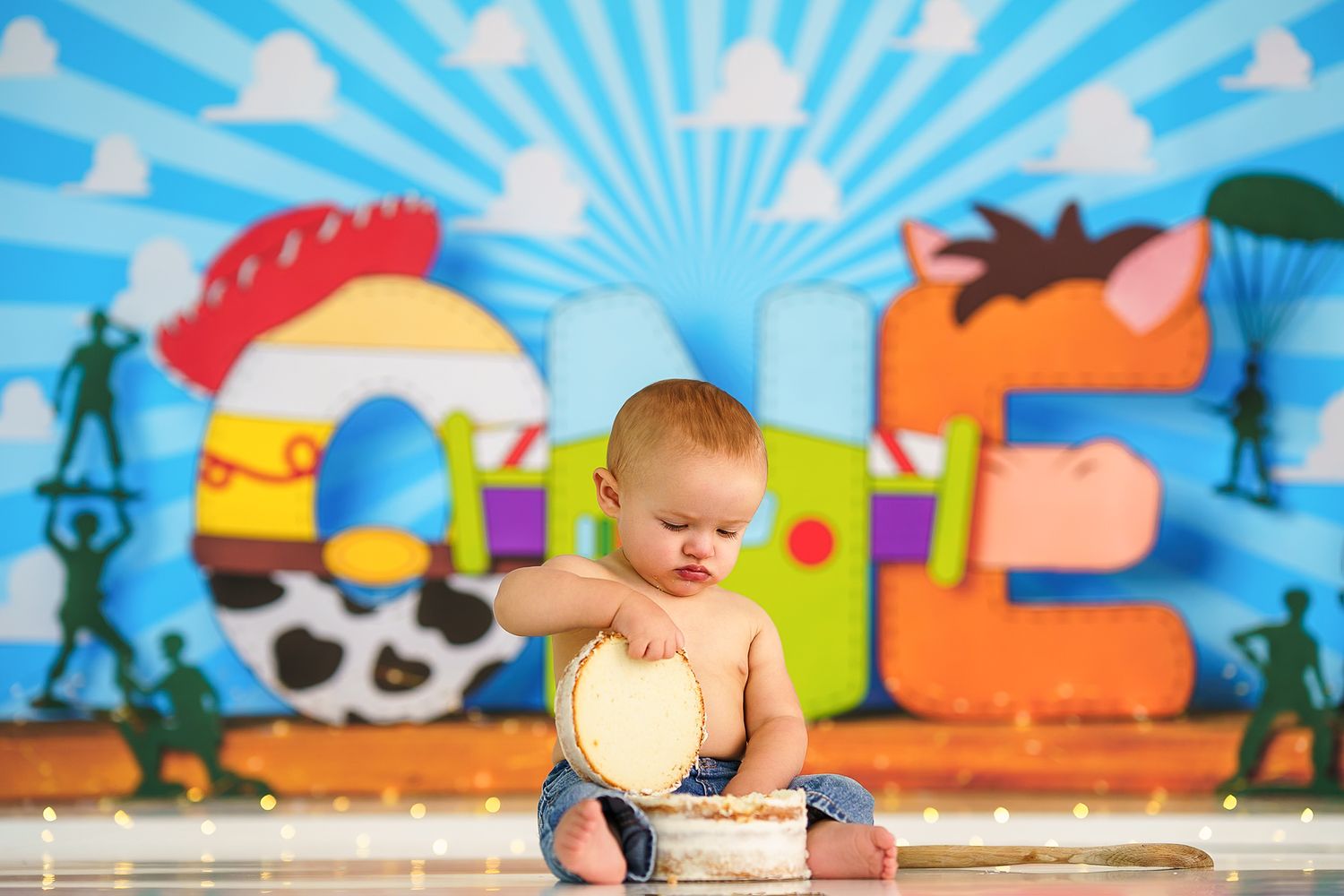 Colorful children's party setup with bright blue sunburst backdrop and festive decorations.