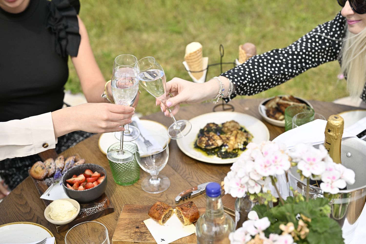 Table settings and food at an outdoor garden party.