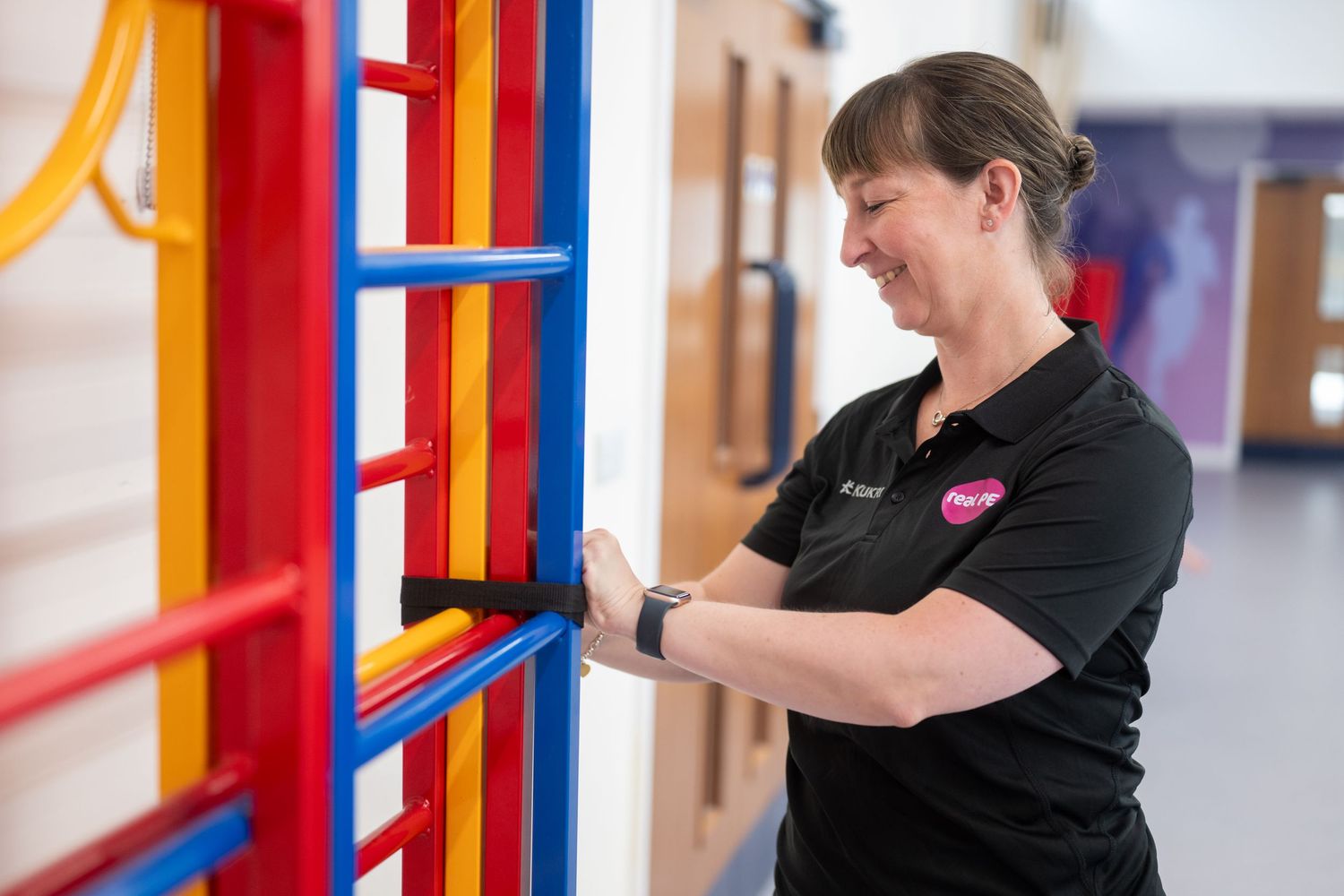 Colorful red and blue playground equipment or therapy bars in an indoor facility.