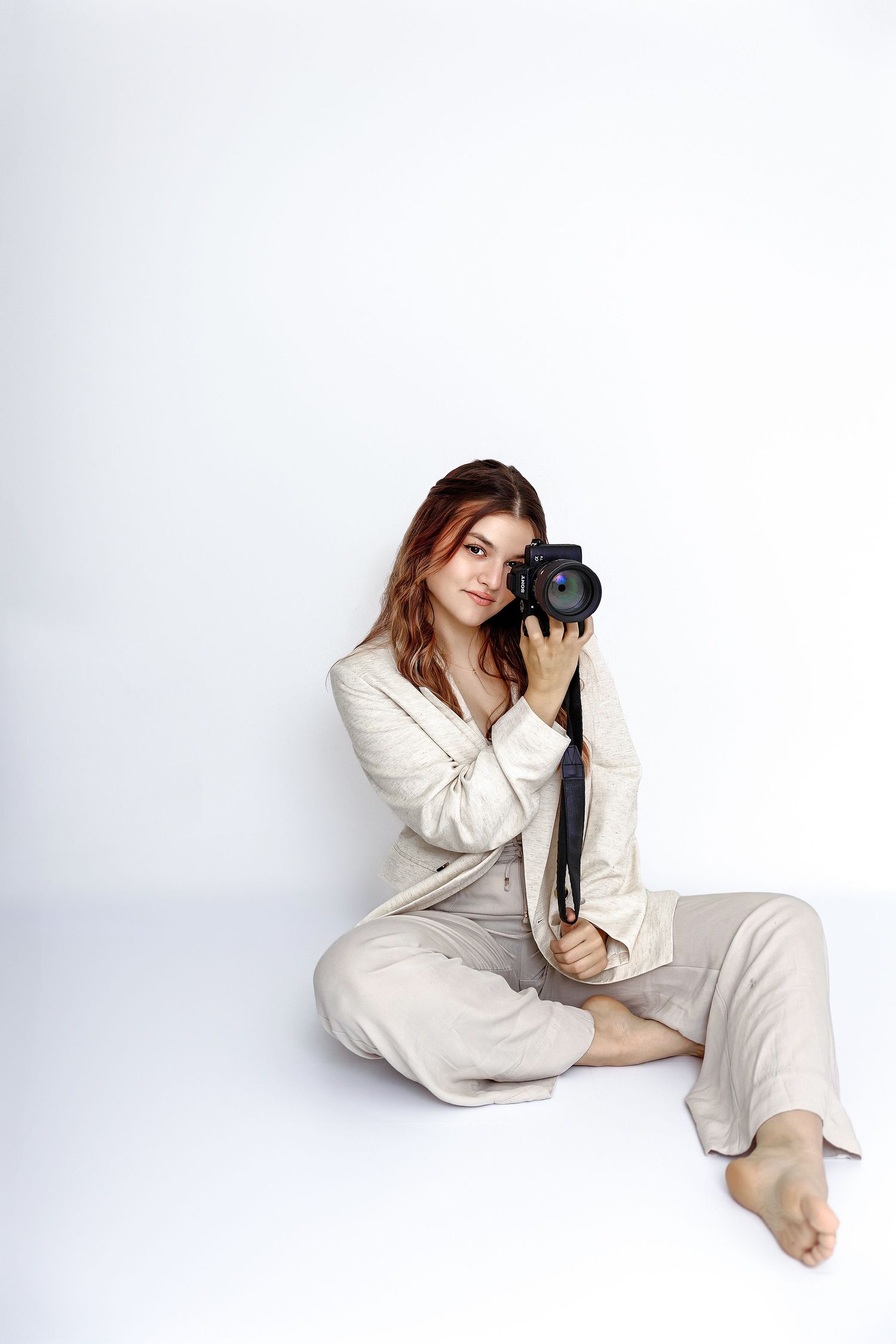 Professional photographer Mima sitting with her camera, welcoming connection, diverse cultures, and open conversations in Ljubljana.