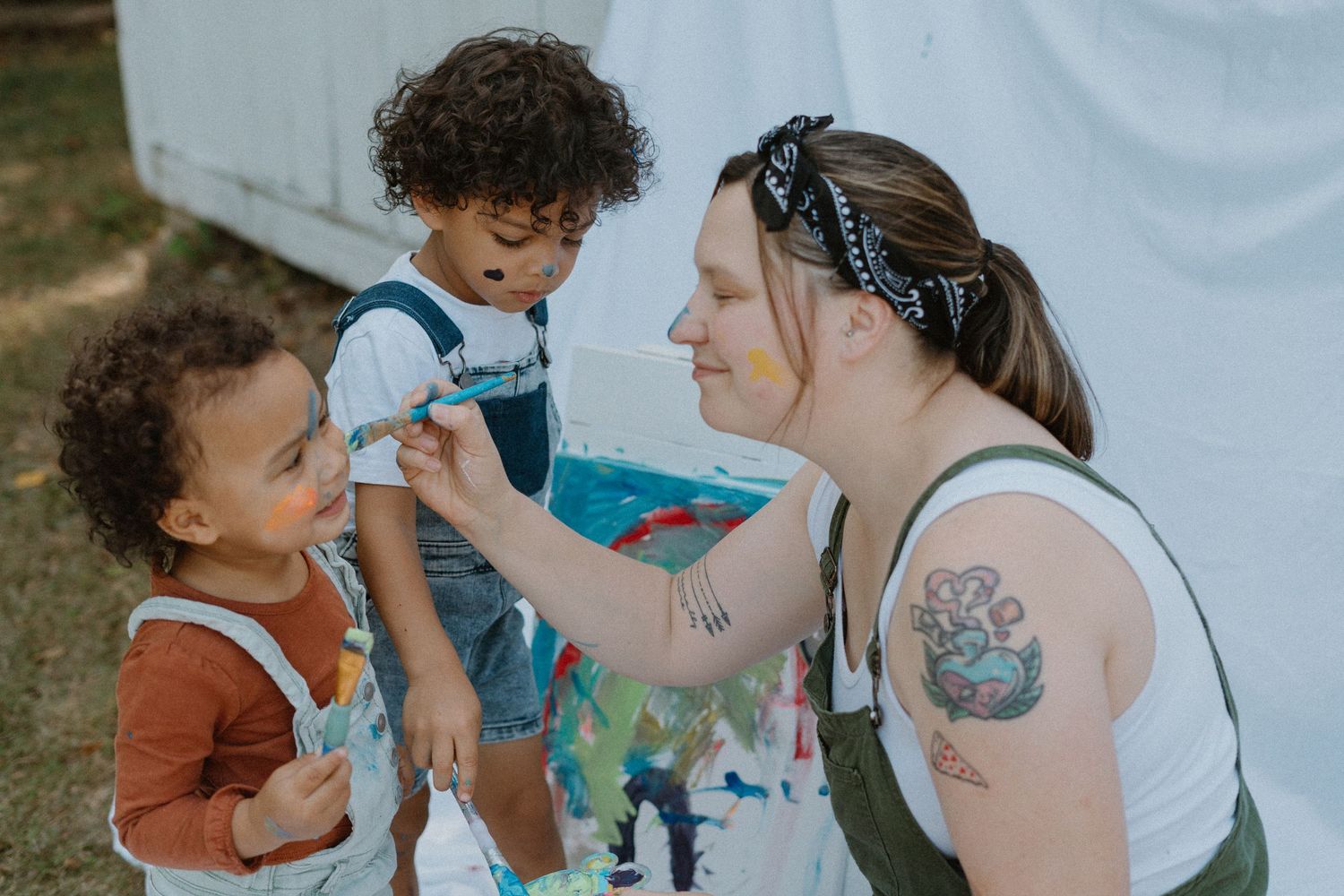 Creative art time with children painting and playing with colorful materials.