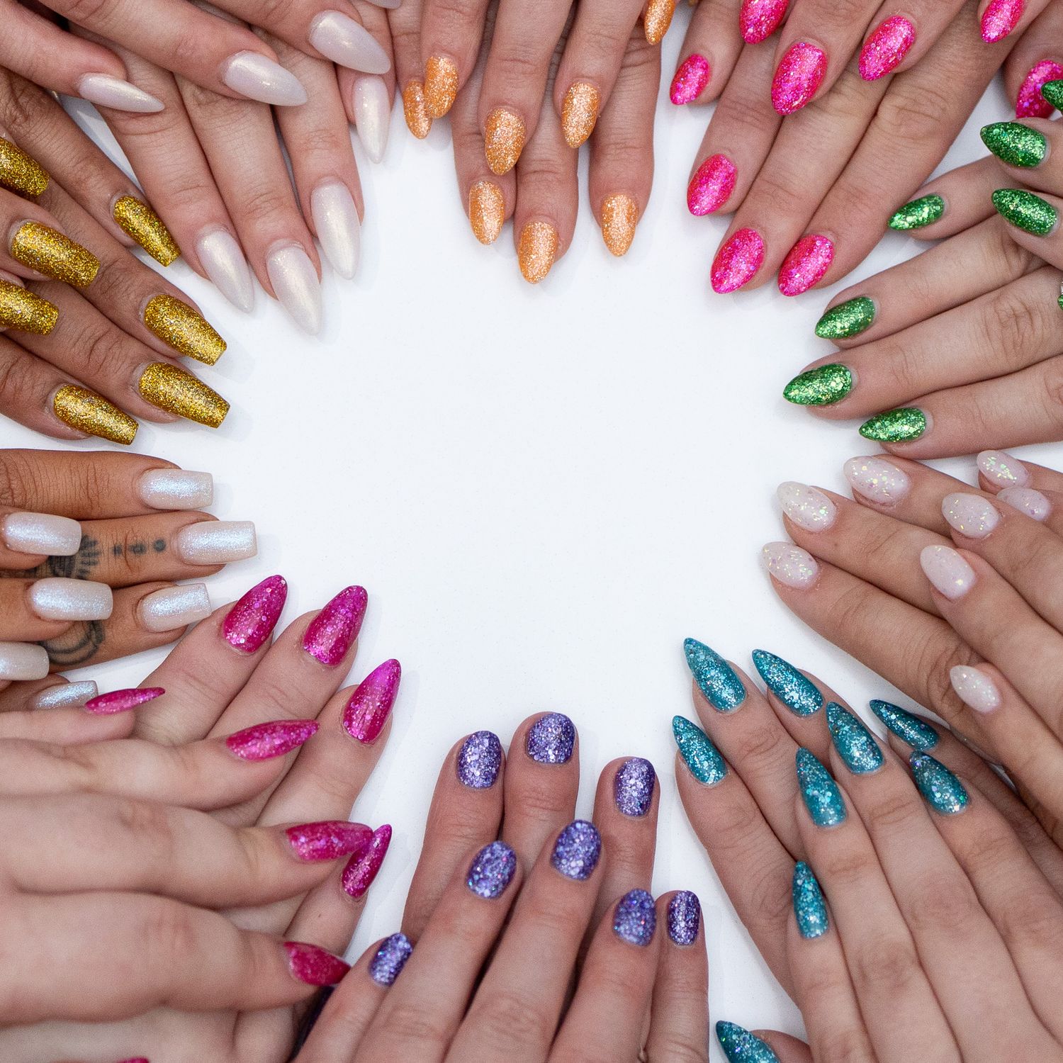Colorful manicured hands arranged in circle pattern showing various metallic and glitter nail designs.