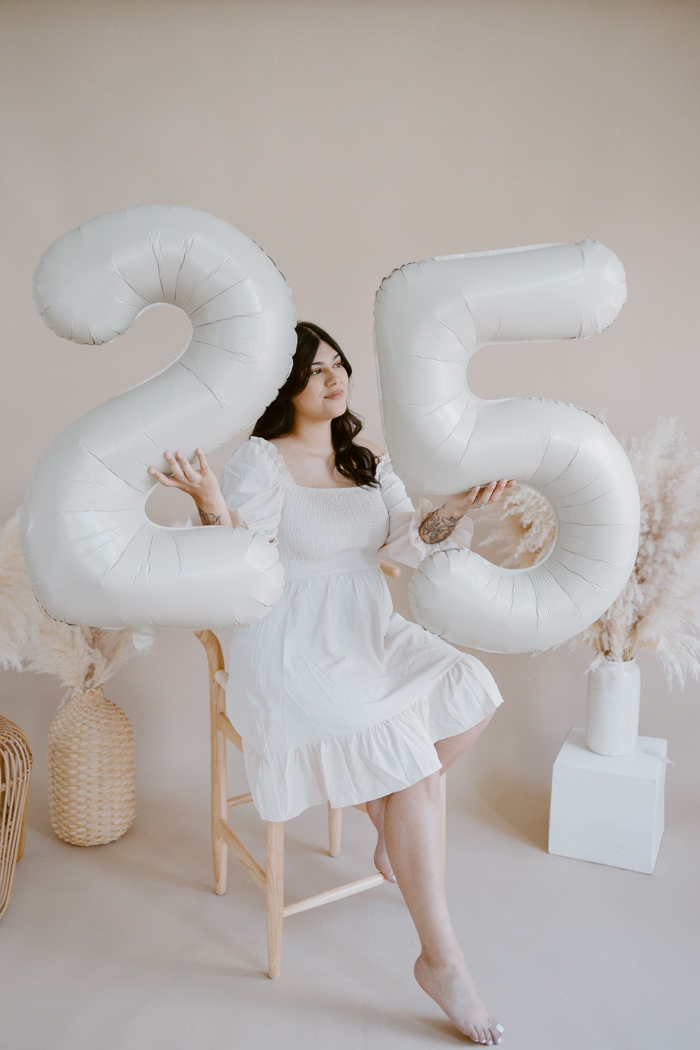 Creative photography with large white cloud-shaped pillows and neutral toned setting.