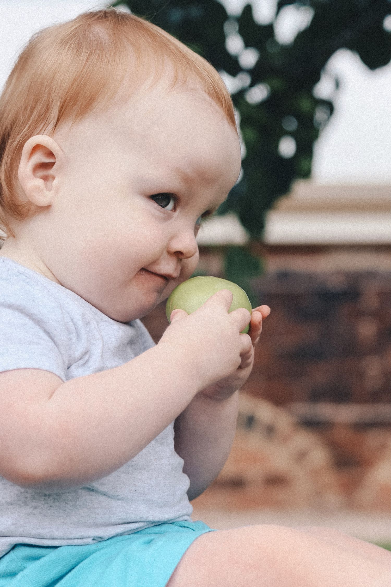 Child smelling apple