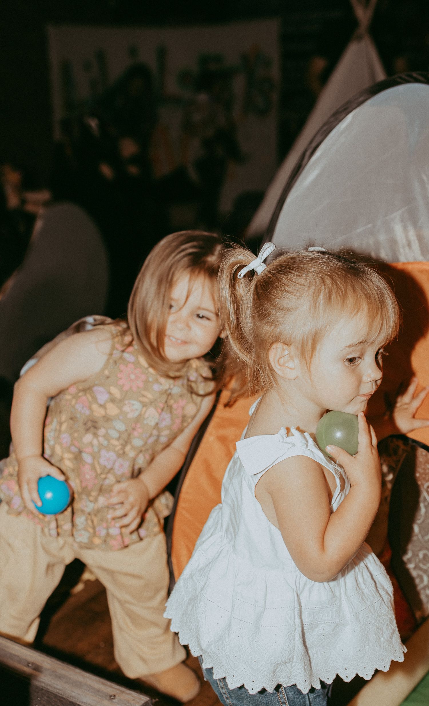 Young children at a colourful indoor event