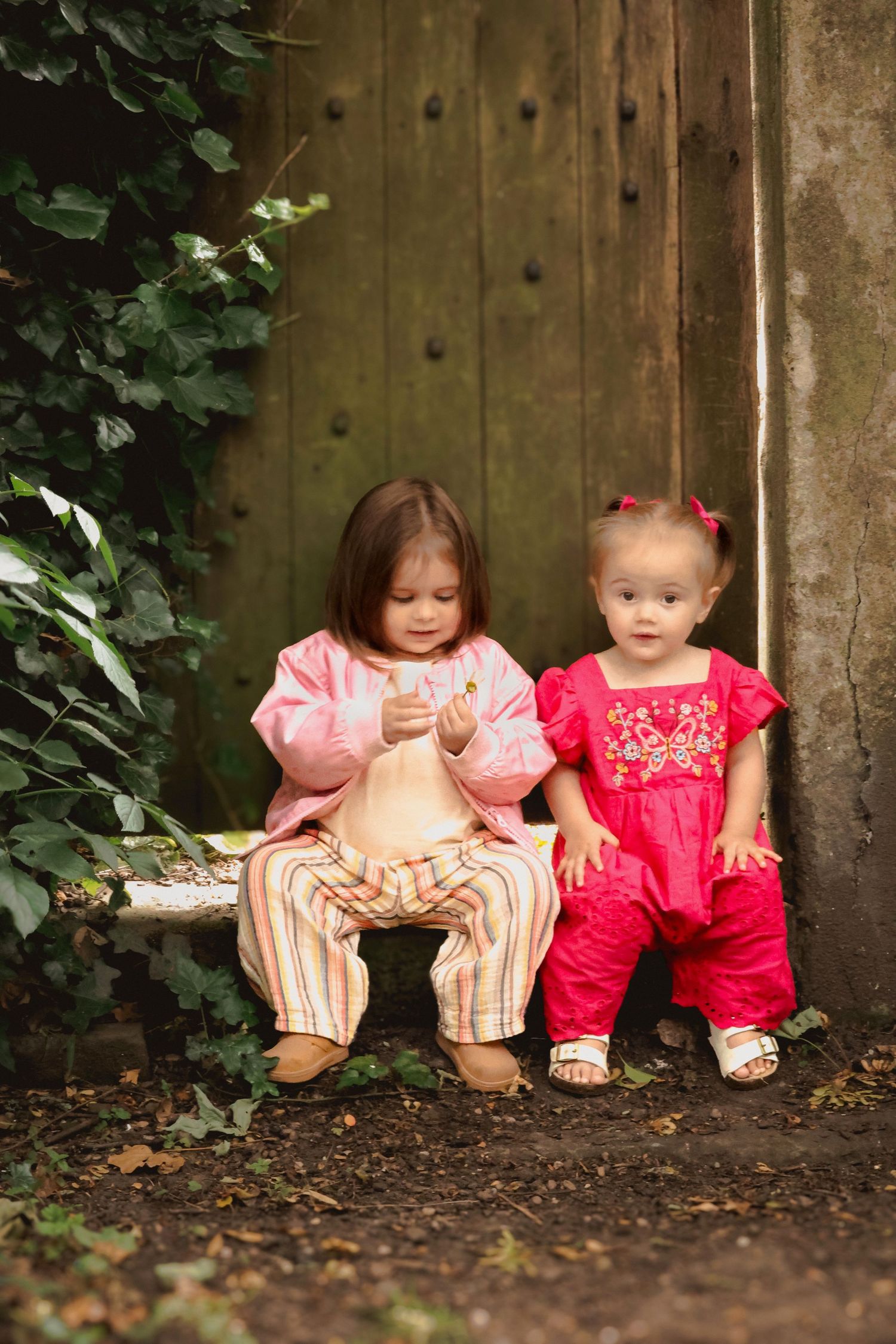 Two children sat on a step