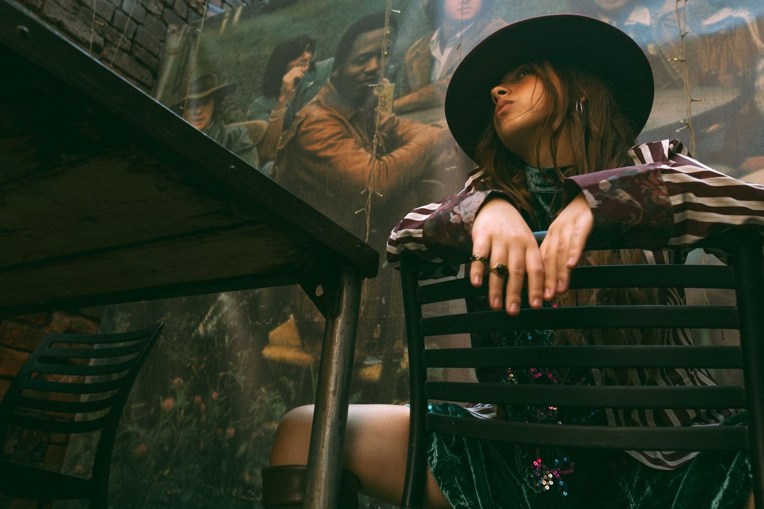 Woman sat on chair in front of old band photograph
