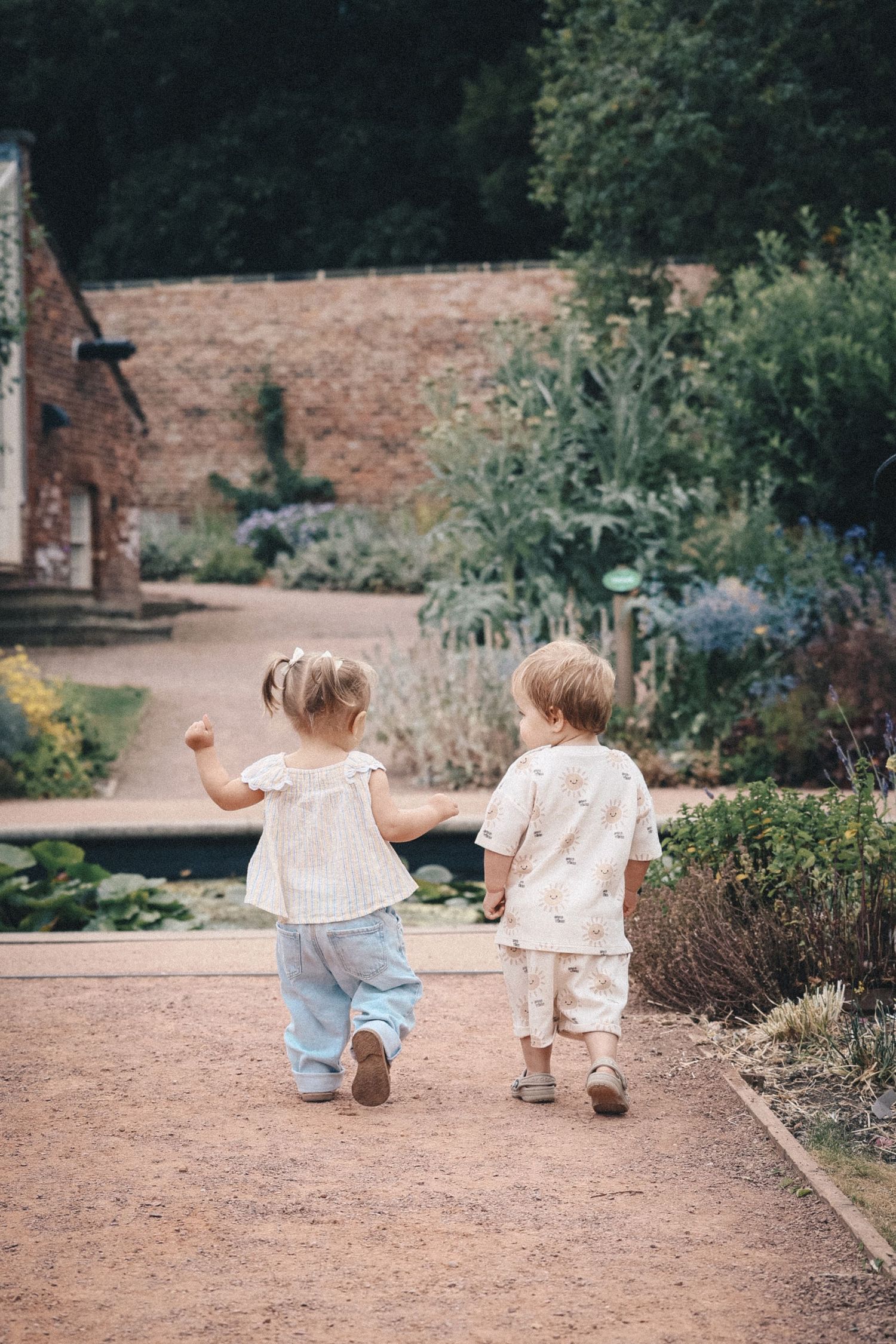 Two children walking away down a path