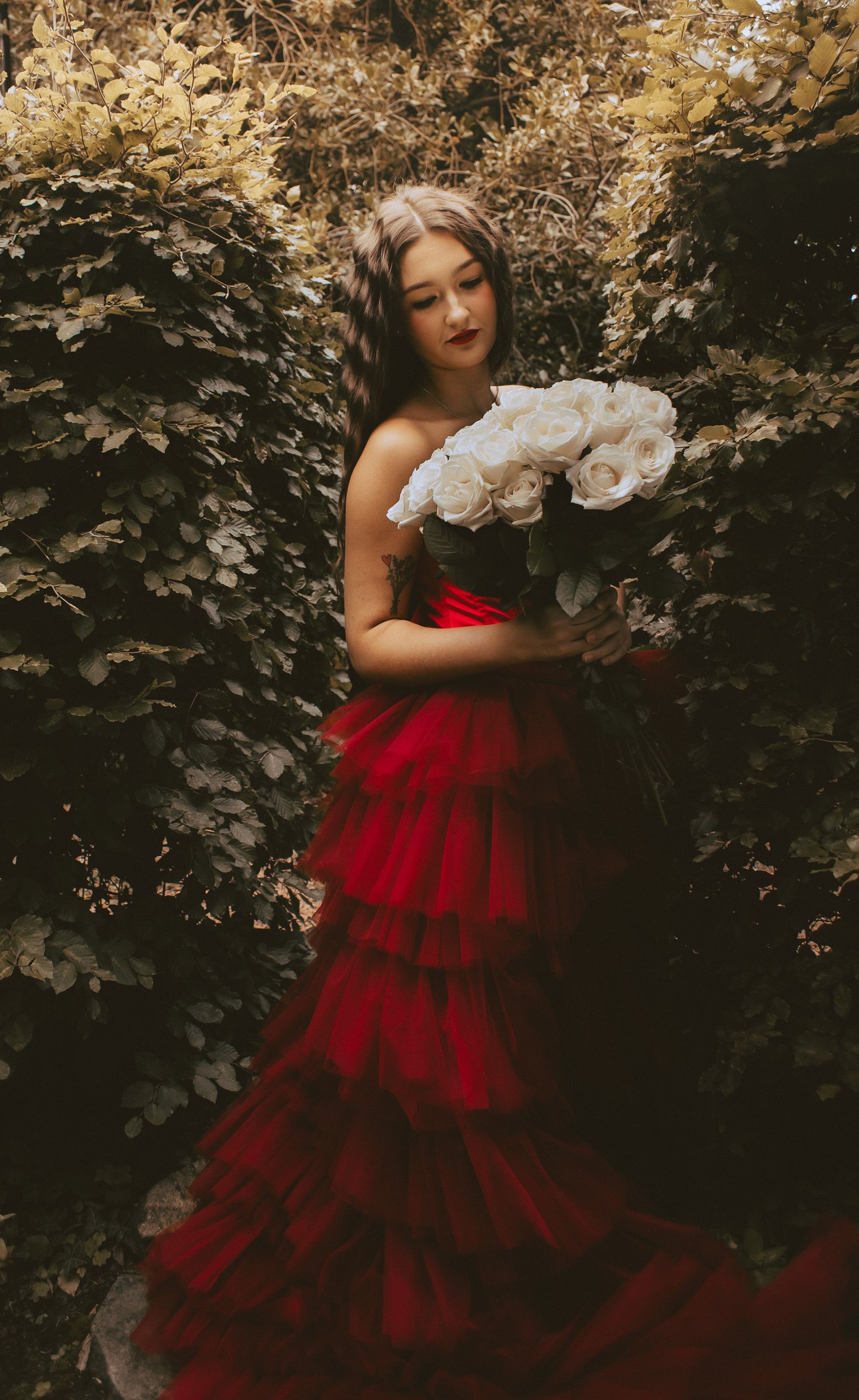 Woman smiling at flowers