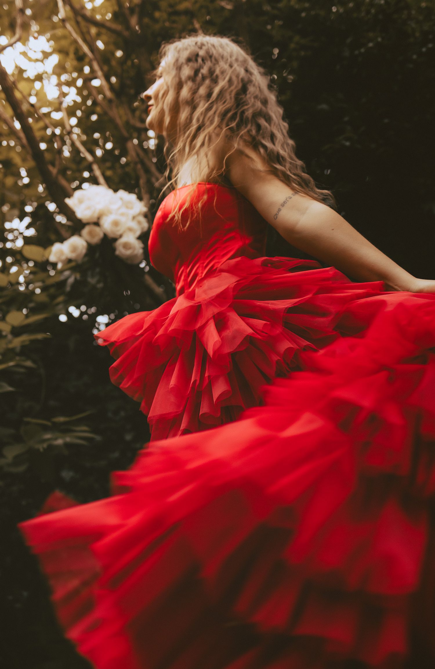 Woman dancing outside under trees