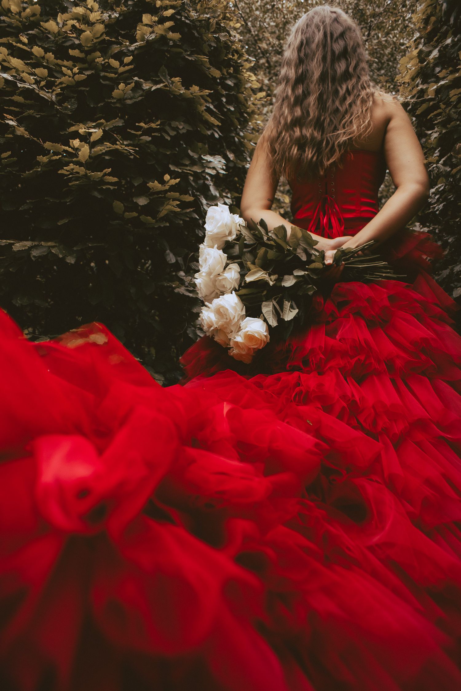 Woman holding bouquet of white roses