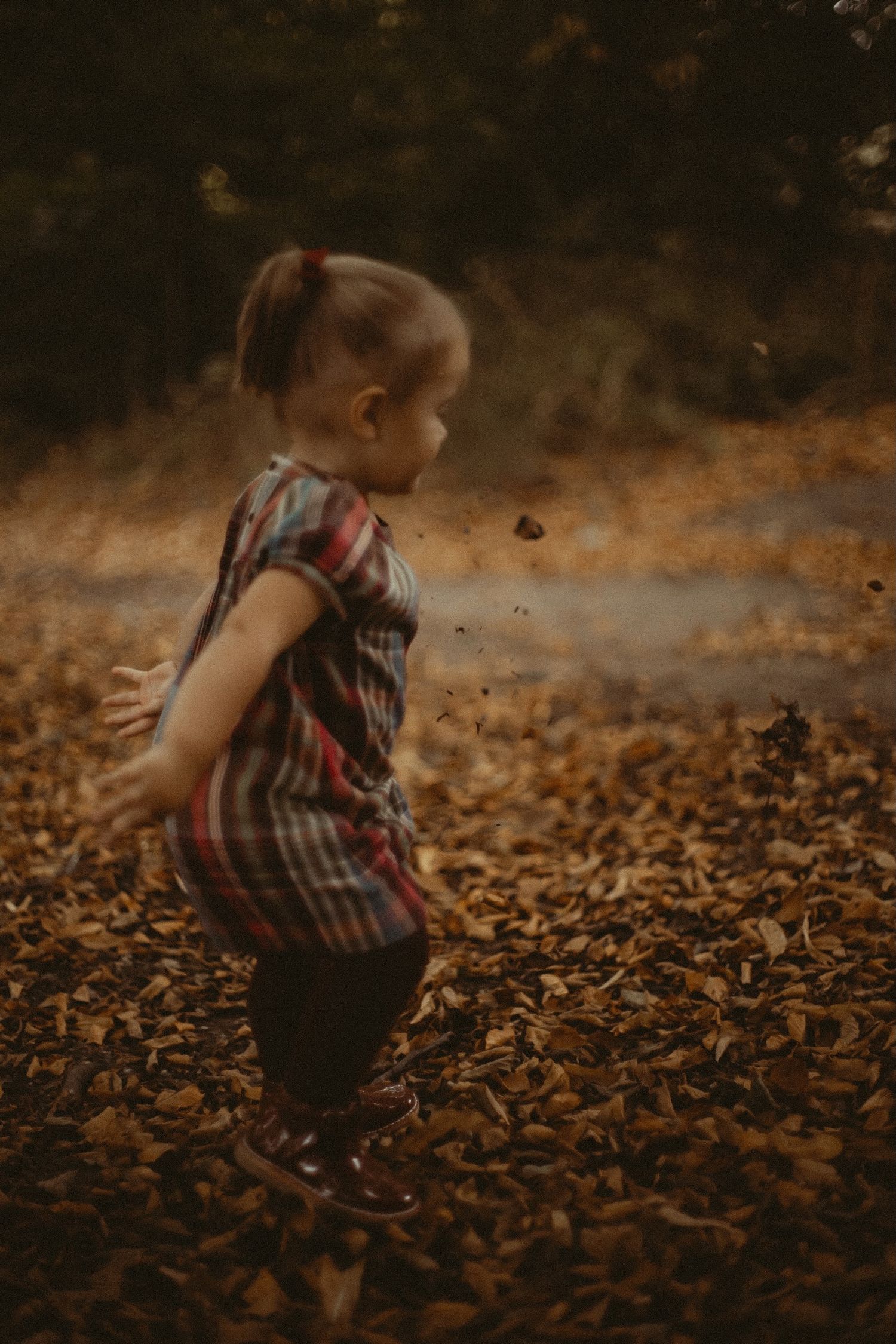 Child dancing in leaves