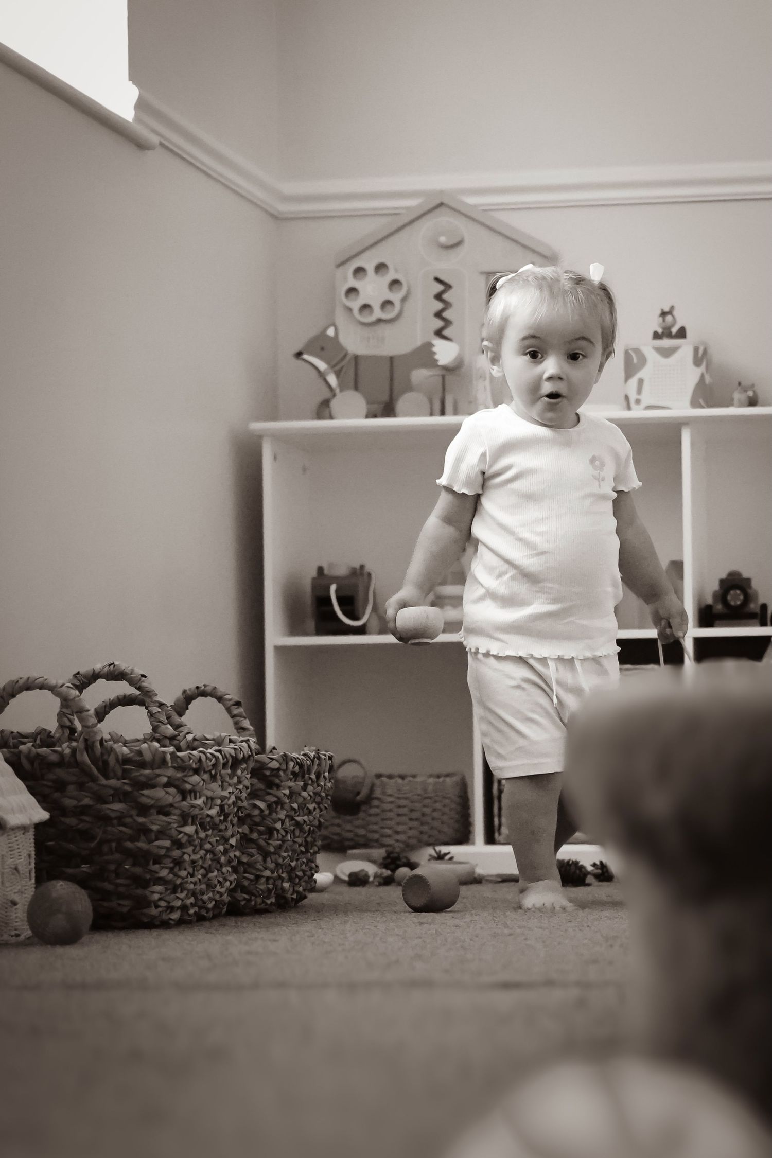 Black and white portrait of child playing in playroom