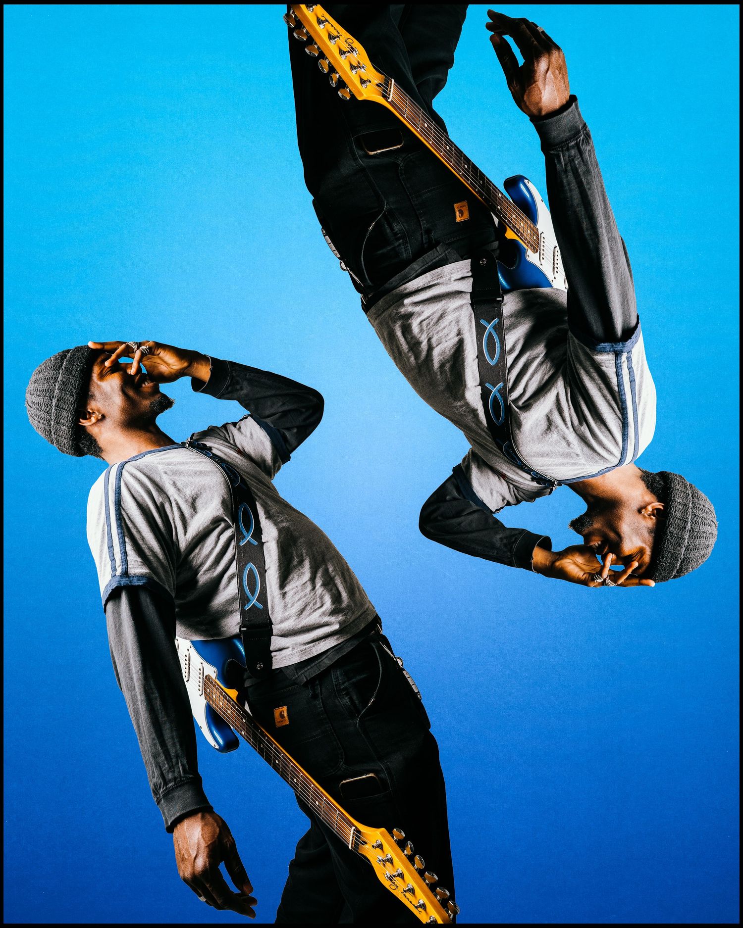 Creative mirrored double exposure of guitarist with yellow guitar on blue background.
