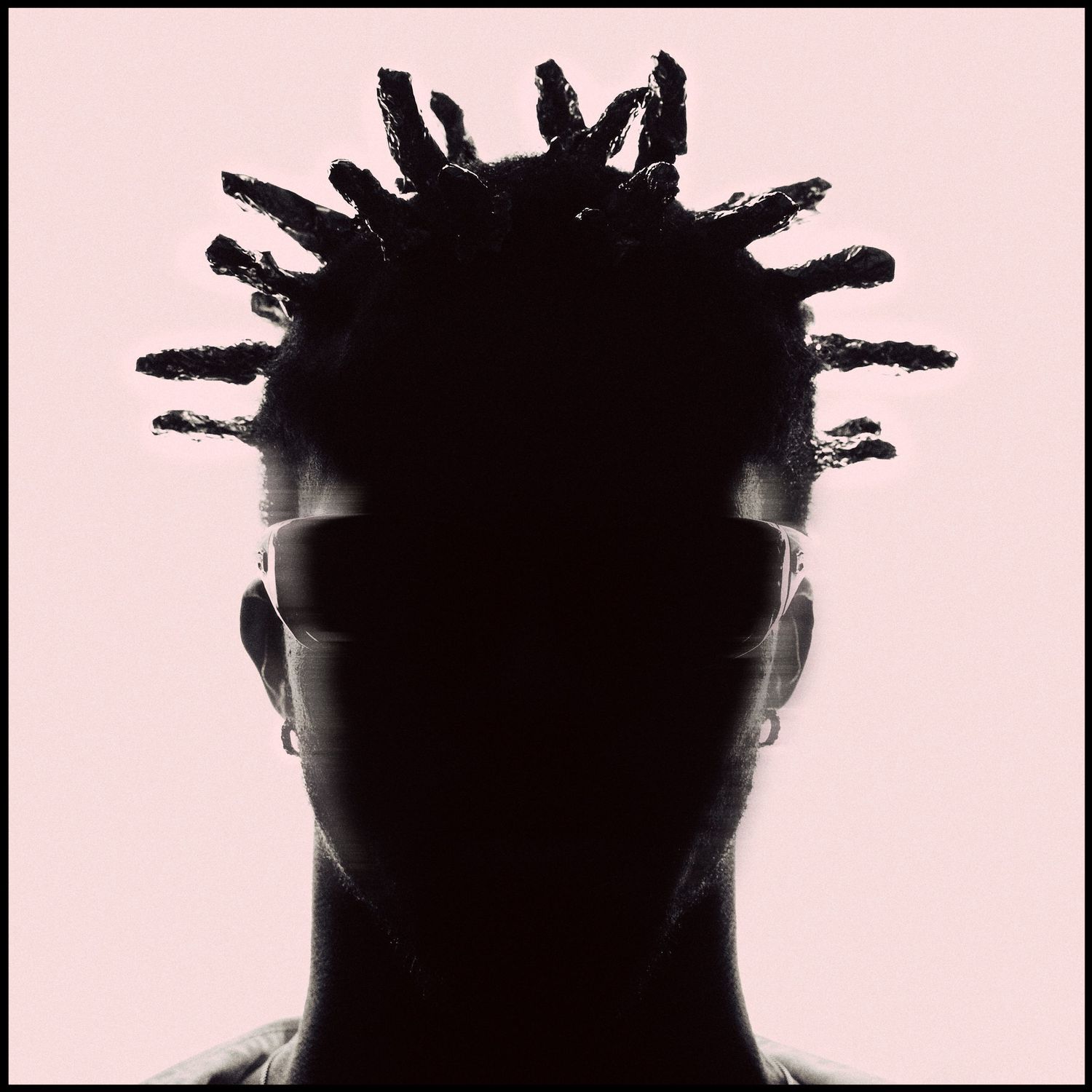 Silhouette portrait of a person with dramatic loc hairstyle against a soft pink background.