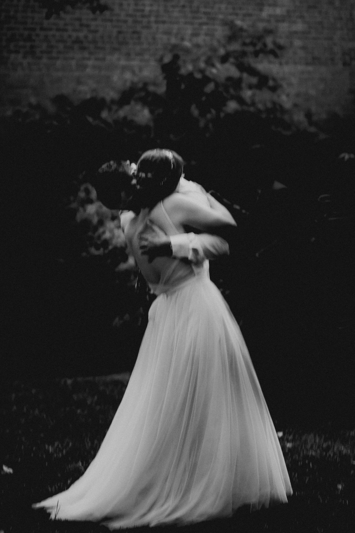 Dreamy & romantic wedding couple embrace during a dusk first dance