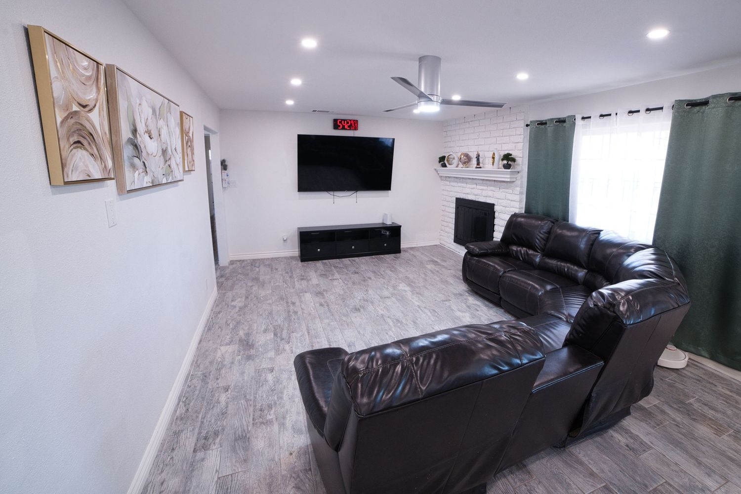 communal living room with TV and sectonal sofa at 1st Care Facility, home based RCFE, residential care facility for elderly in Highland, CA