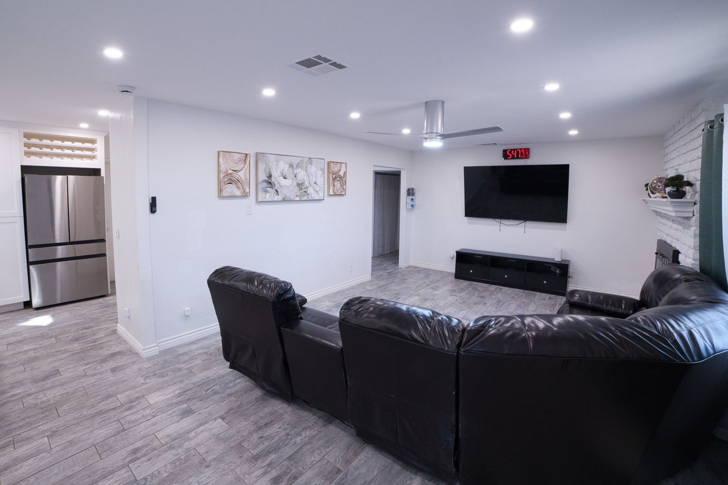communal living room with TV and sectonal sofa at 1st Care Facility, home based RCFE, residential care facility for elderly in Highland, CA