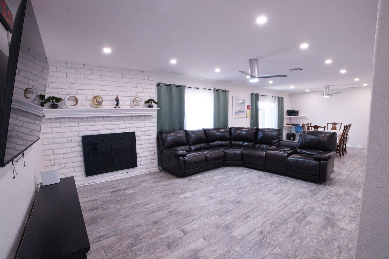 communal living room with TV and sectonal sofa at 1st Care Facility, home based RCFE, residential care facility for elderly in Highland, CA