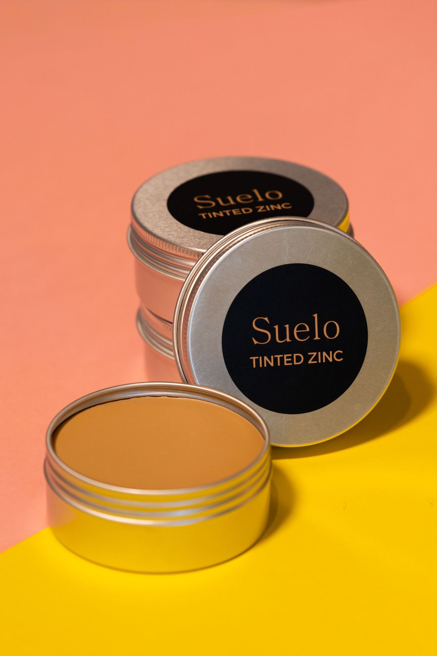 Claire House Photograph business product photograph of Suelo natural zinc on a bright pink and yellow background.