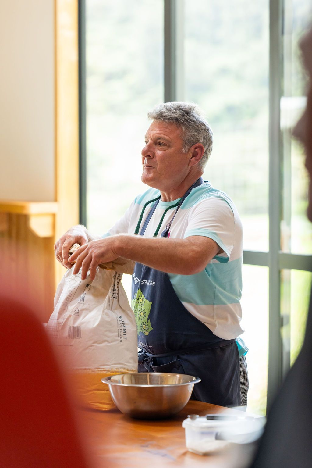 Claire House Photography event photograph of a baker giving instructions at a Flavours of Plenty event.