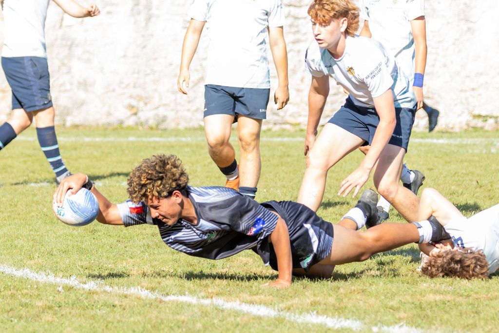 Claire House Photography sports event photograph of a boy scoring a try in sevens rugby.