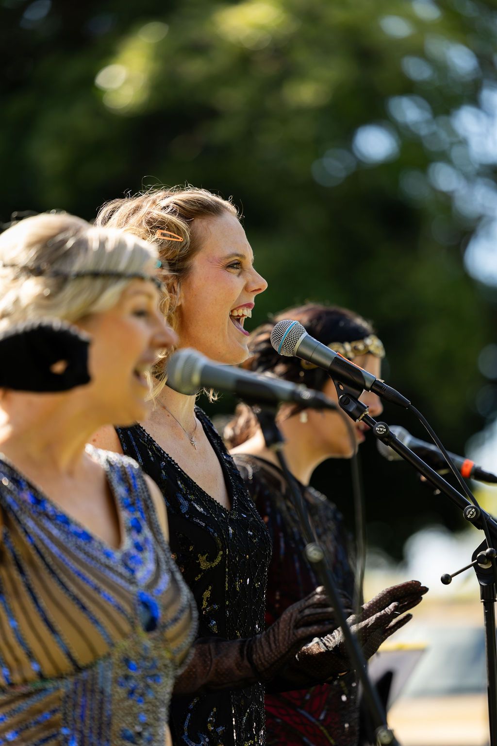 Claire House Photography event photograph of three jazz singers at an outdoor concert.