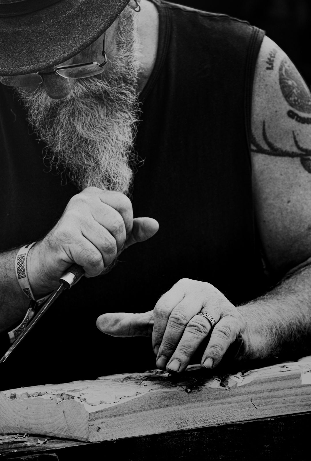close up of man carving a piece of wood