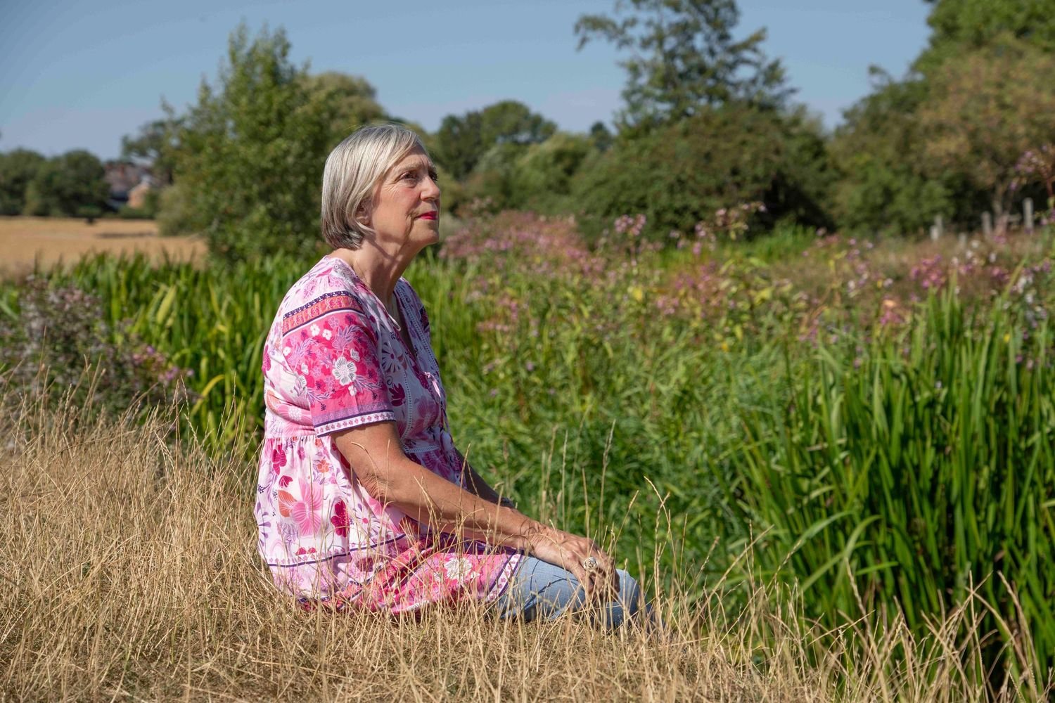 Debbie Mcleod mid life mystic witch portrait. Female sat by a stream in the Warwickshire countryside.