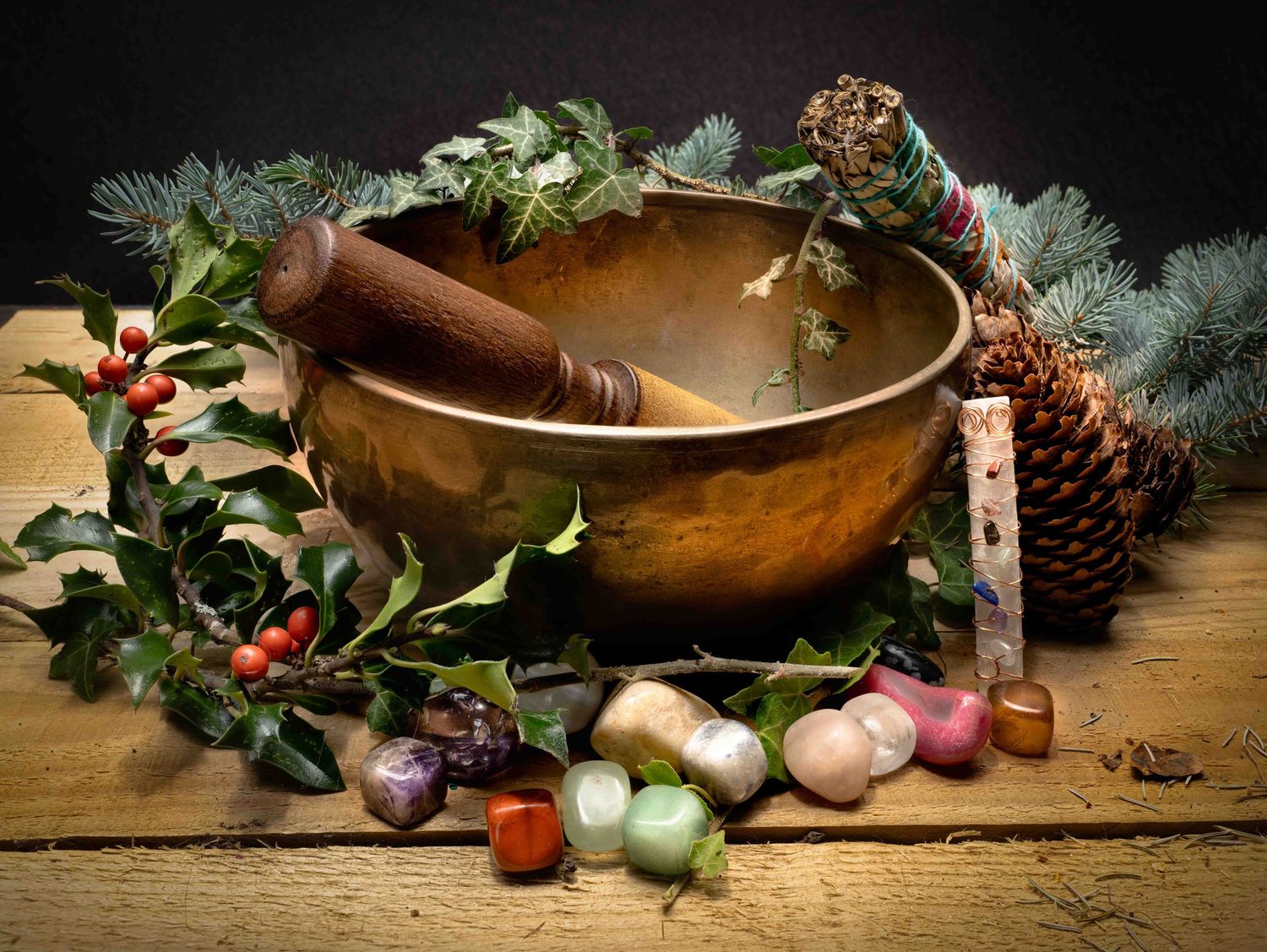 Creative image of a witches alter with singing bowl smudge stick and crystals