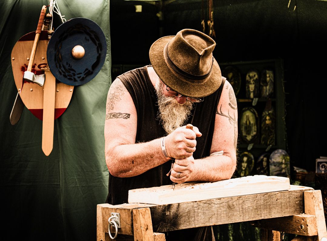 Portrait of man carving a piece of wood