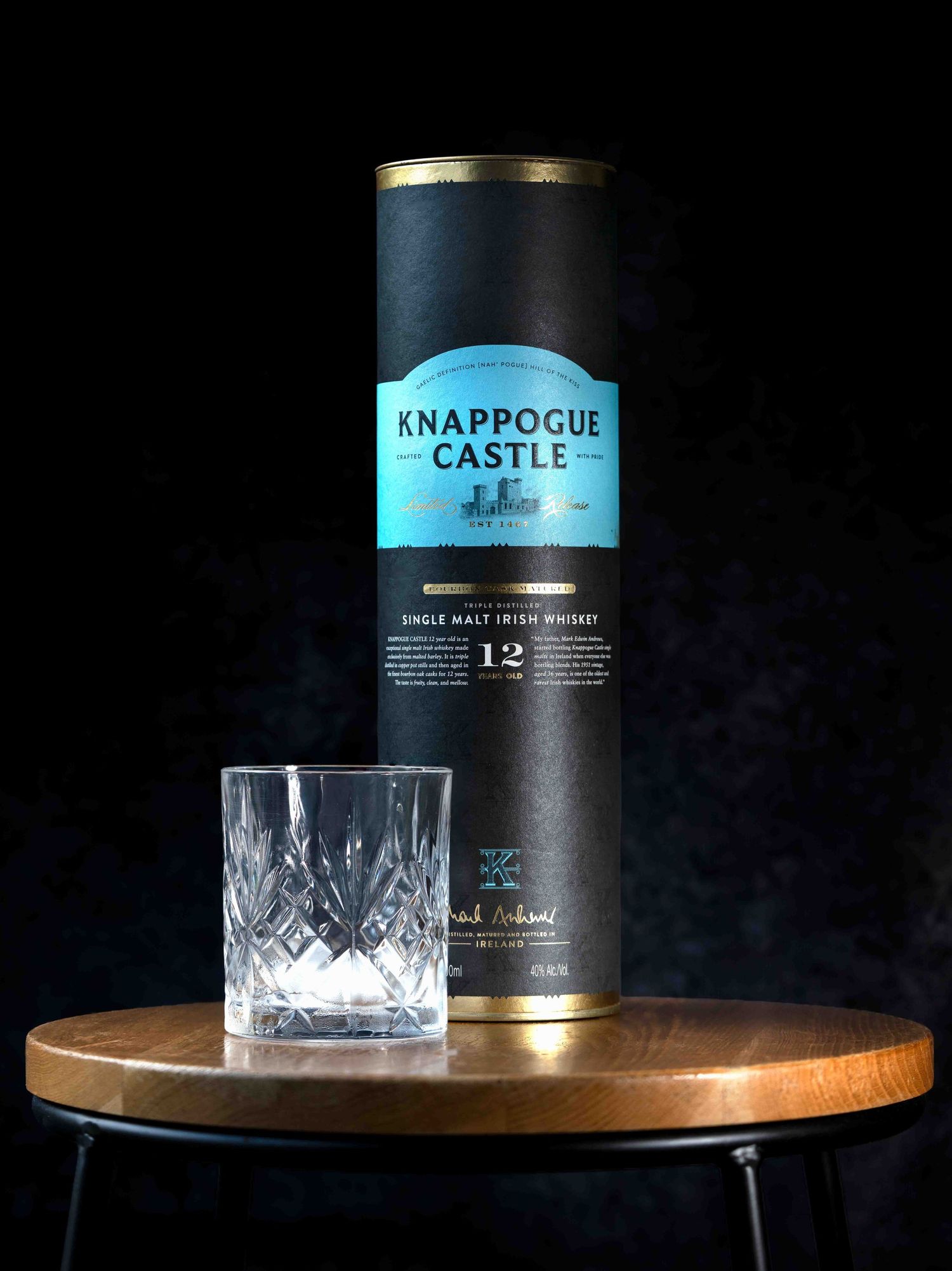 Studio product shot of bottle of whiskey with crystal glass