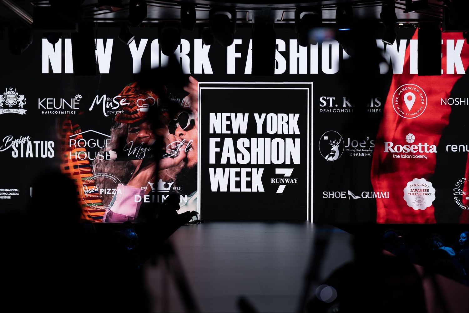 New York Fashion Week signage display with sponsor logos and branding at a glamorous NYFW event backdrop.