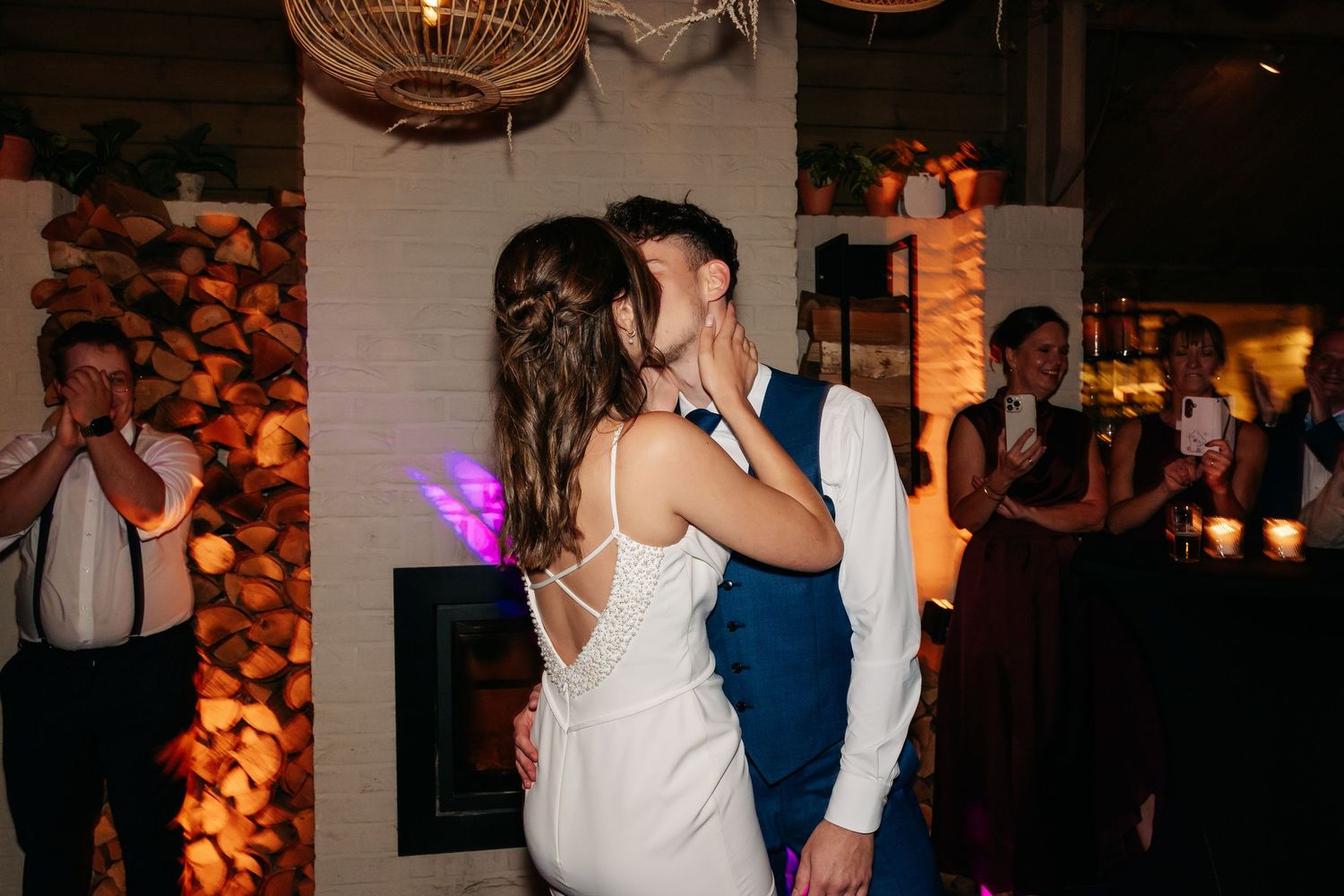 Newlyweds sharing a tender first dance kiss at their wedding reception.