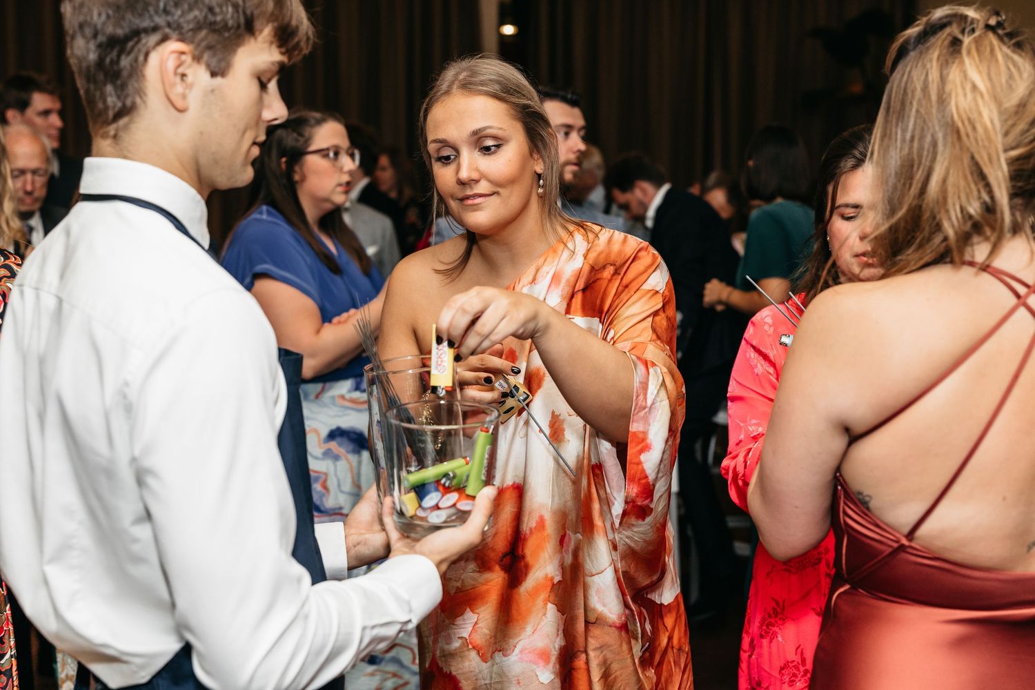 Wedding guests mingling and sharing appetizers during a cocktail hour reception.