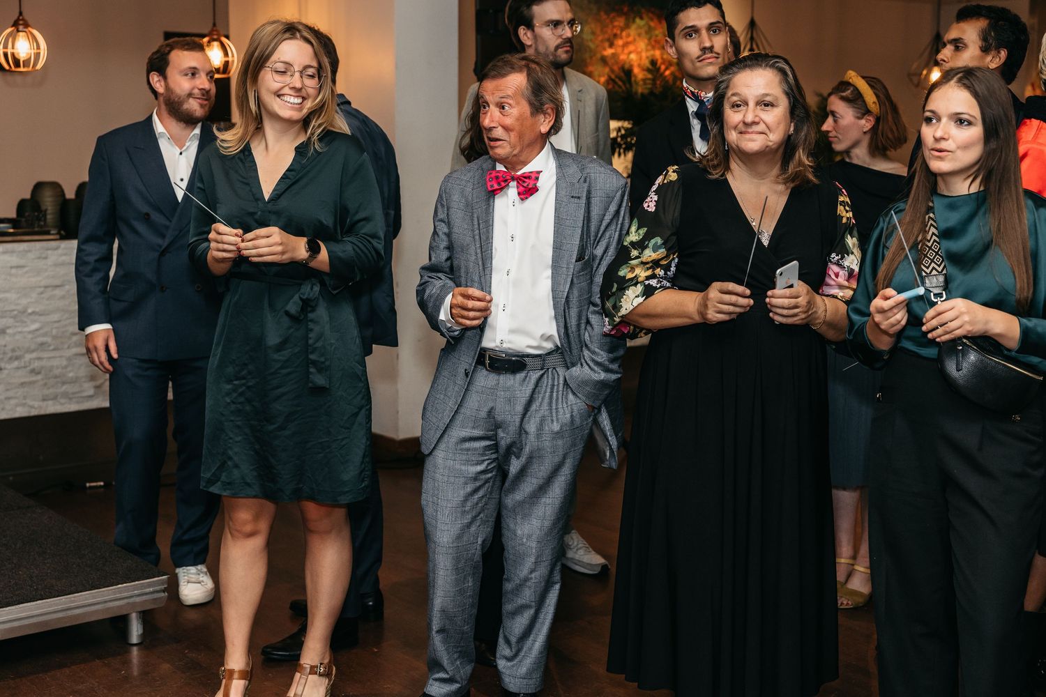Wedding guests walking together and smiling during a festive reception celebration.