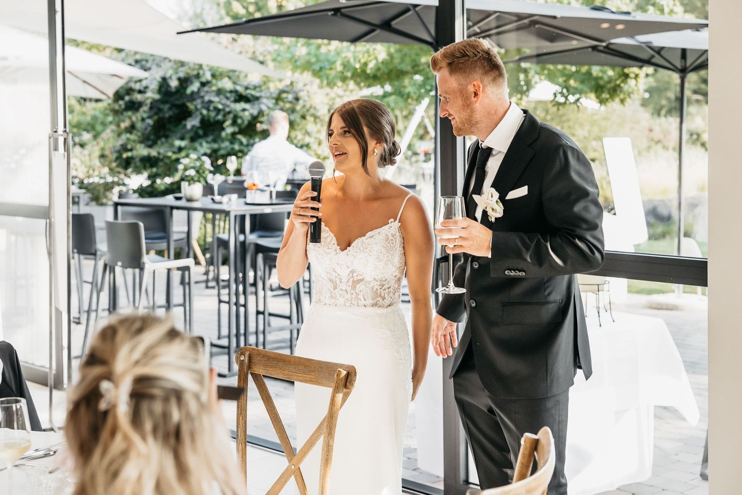 Bride and groom sharing a toast with champagne glasses at their wedding reception.