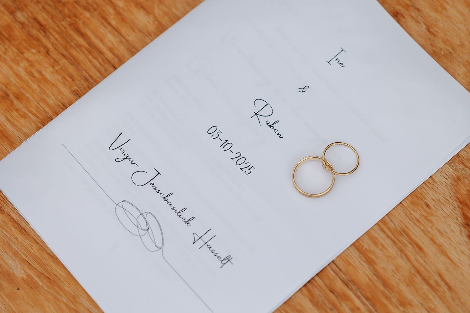 Wedding ceremony program with two gold rings on a white card dated 03.10.2023.