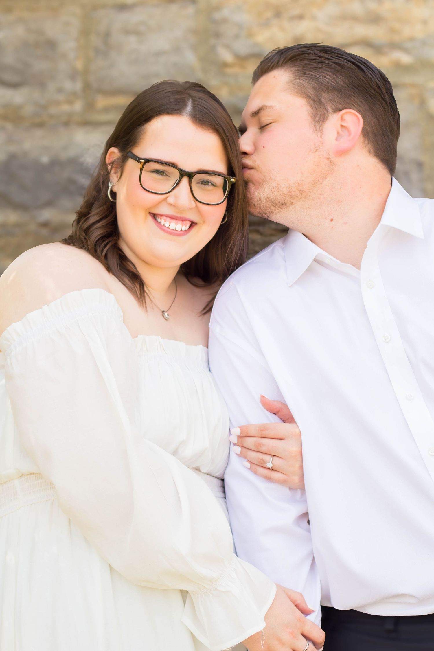 Couple smiling together during an outdoor engagement session.