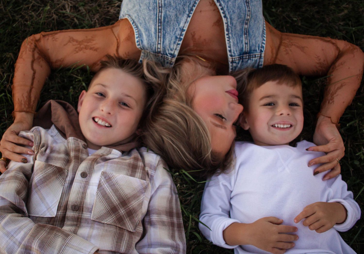 Mother cuddling her sons during a close-up family portrait