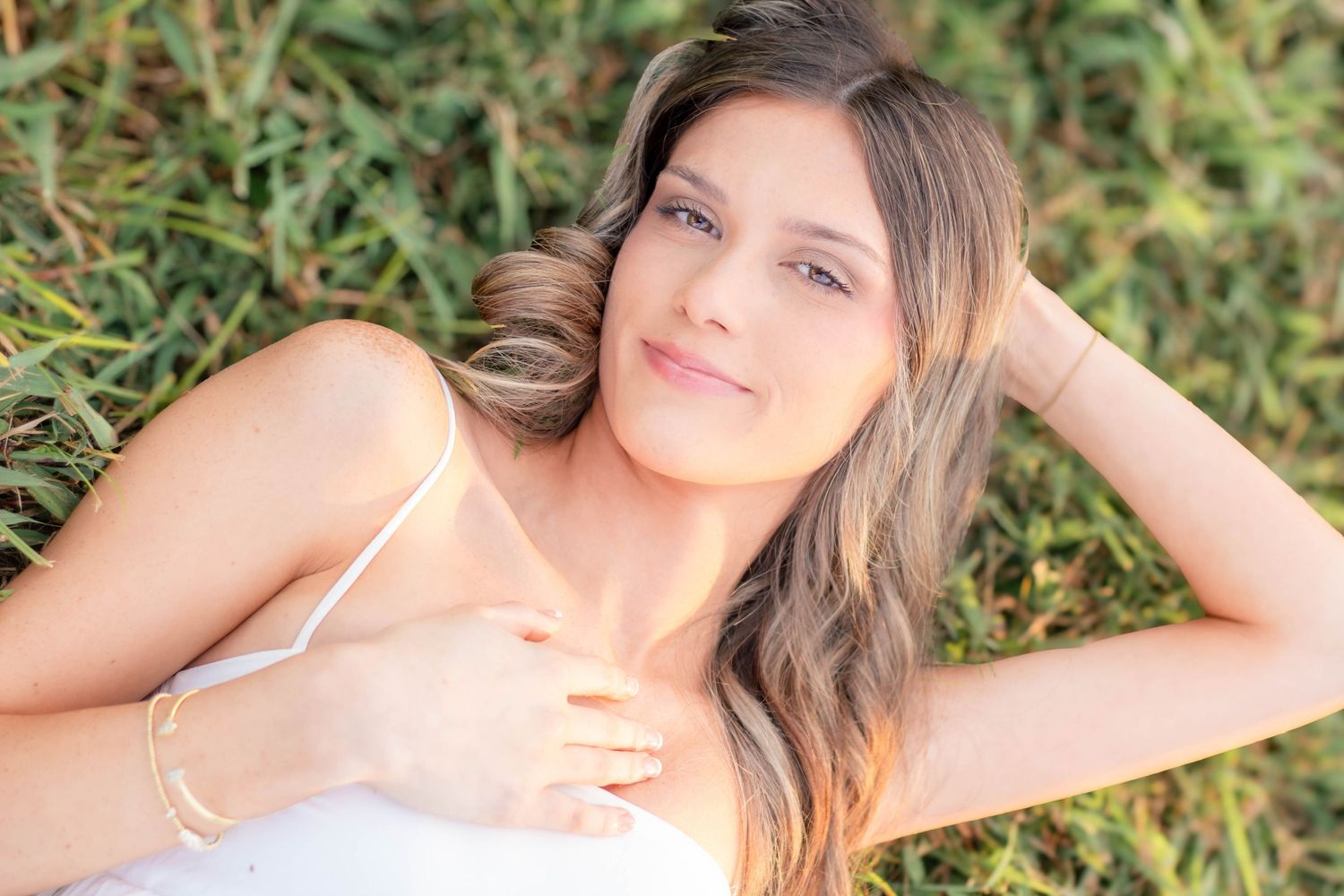 High school senior girl posing outdoors for a senior portrait session
