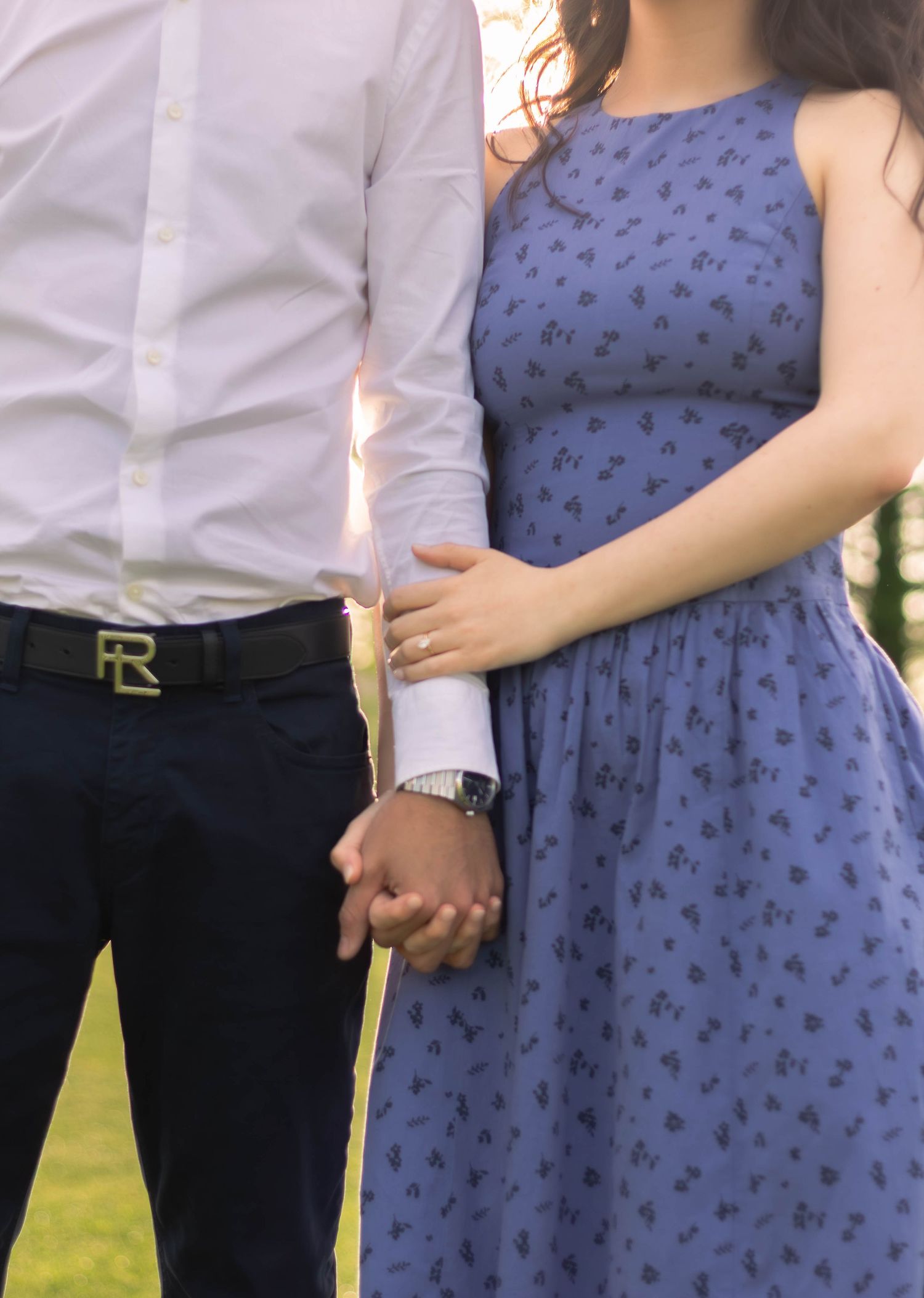 Couple holding hands during an outdoor engagement session.